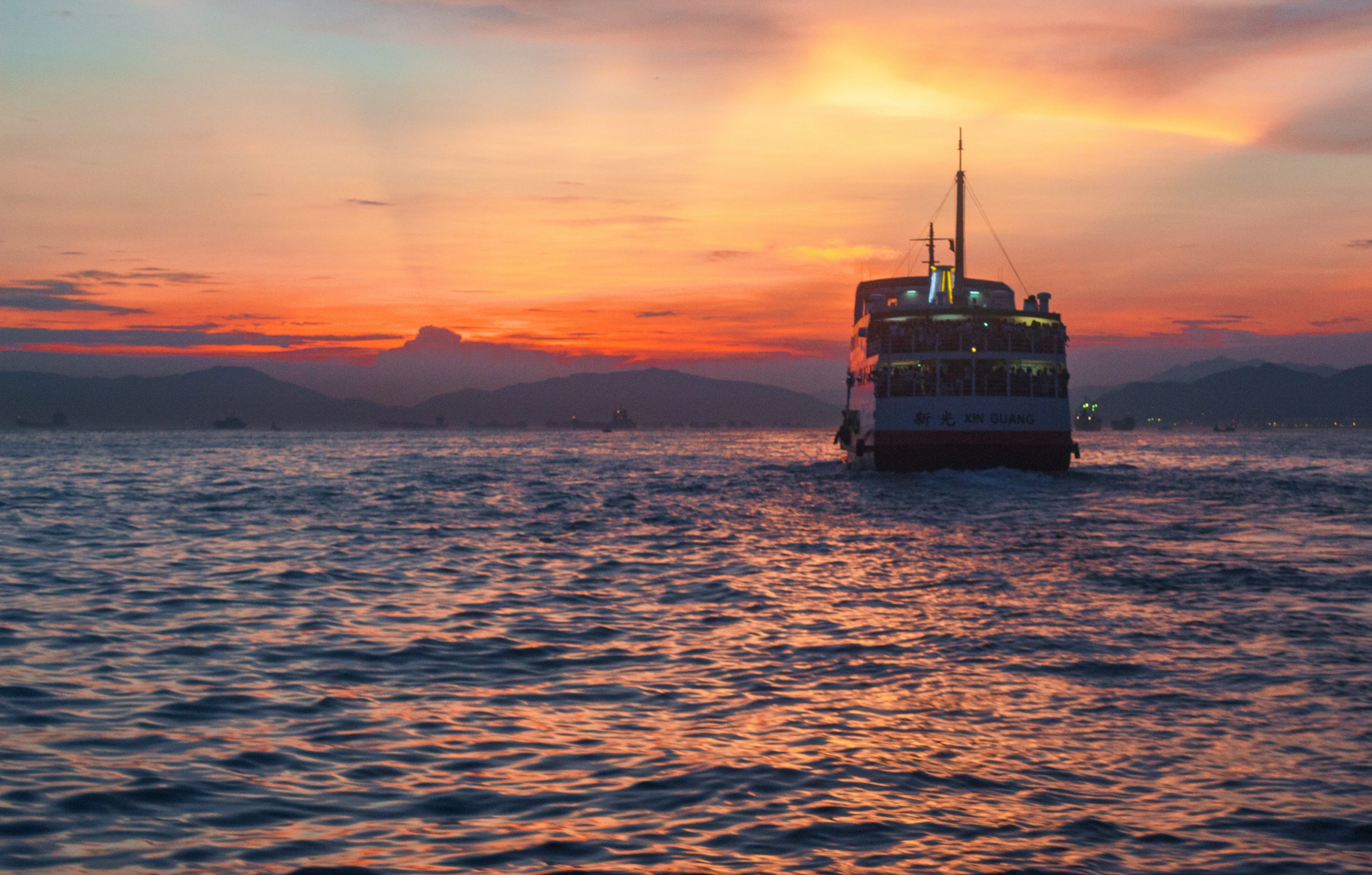 Boat Sailing in Hong Kong sunset